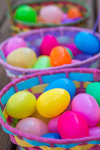 Colorful Easter baskets filled with plastic Easter eggs.