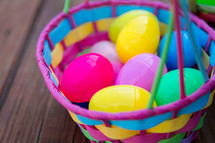 Colorful plastic Easter eggs in an Easter basket.