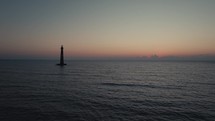 A lighthouse on the  Atlantic Ocean coast of South Carolina during sunrise 