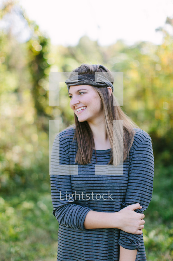 portrait of a teen girl standing outdoors 