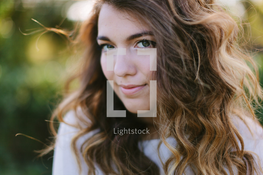 head shot of a teen girl outdoors 