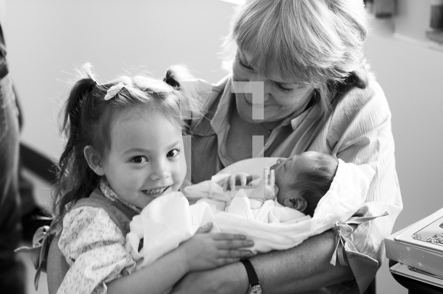 Grandmother With Newborn Baby and Older Sister