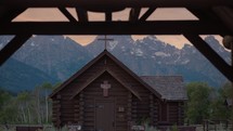 Old Wooden Chapel in the Mountains at Sunset