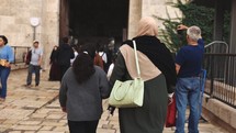 Muslim women walking into old city gate together in middle eastern town culture islam ethnic world travel