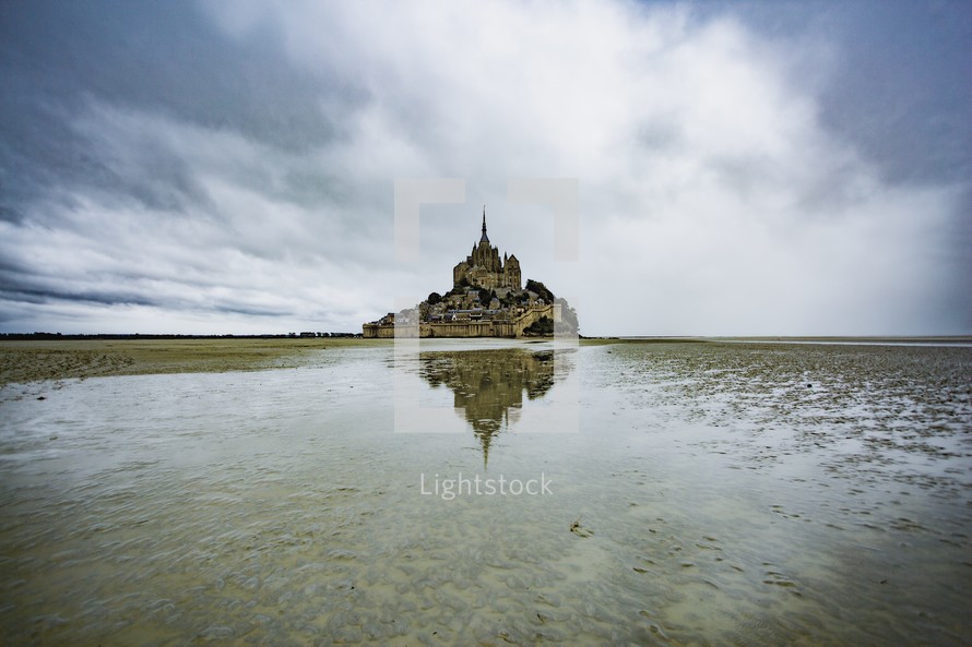 Moody landscape reflection of Mont Saint Michel in France