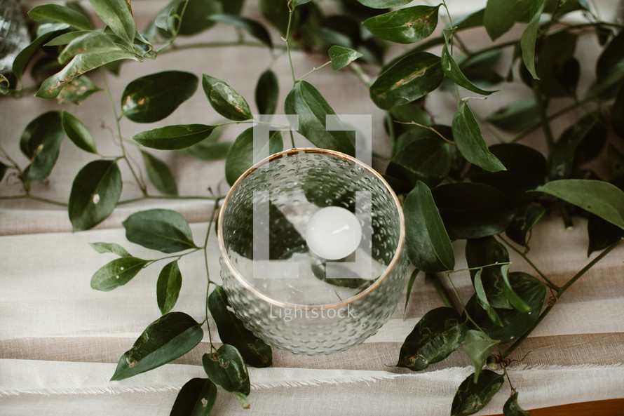 floating votive candle and greenery 