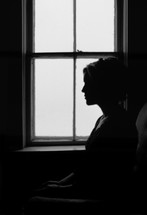 silhouette of a woman in prayer 