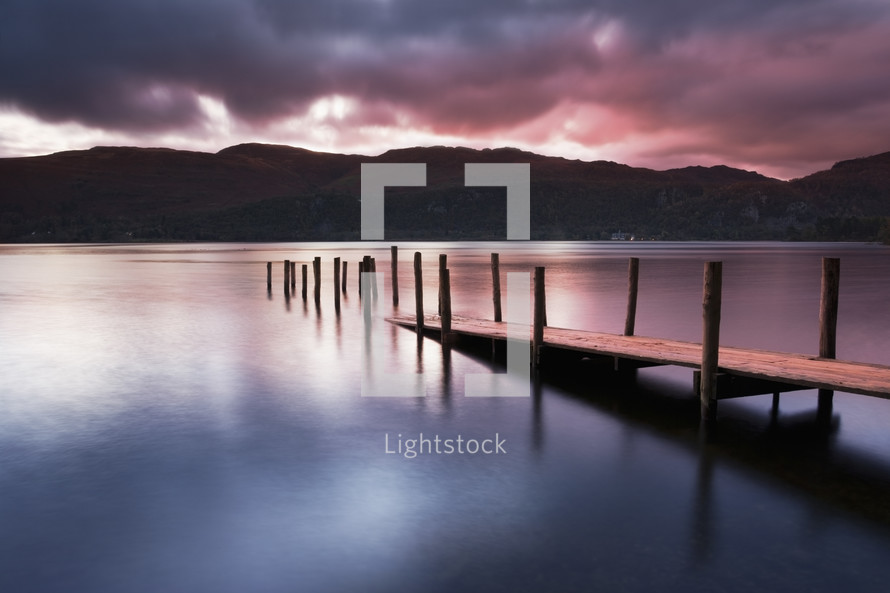 A view across Derwent water lake at dawn, with Jetty in foreground.
Lake District.
Cumbria.
England.
