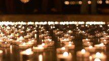 flickering prayer candles in a church