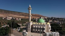 Aerial camera footage of a mosque and surrounding city in Jerusalem, Israel