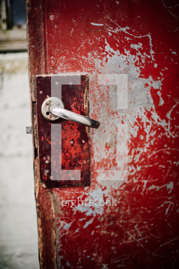 door handle on an old red door 