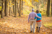 couple walking in an autumn forest 