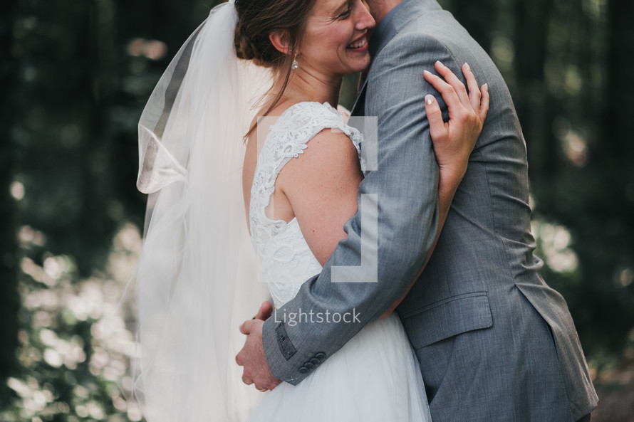 bride and groom hugging 