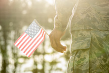 soldier holding an American flag 