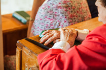 elderly woman praying in church 