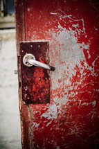 door handle on an old red door 
