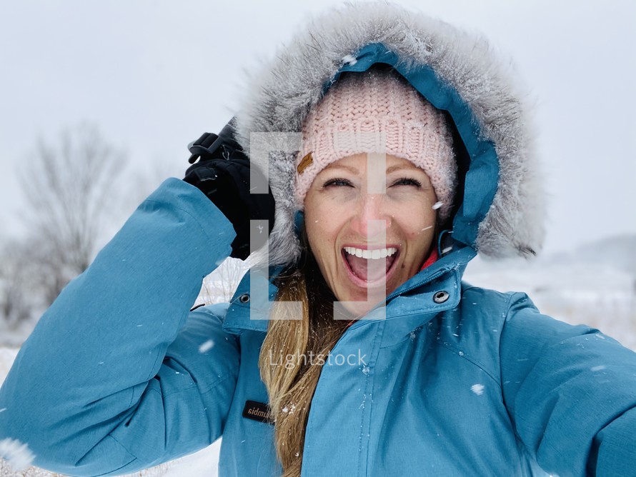 happy woman in a winter coat 