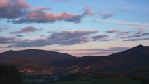Mountain hilly rural landscape at dusk, blue hour, transition from day to night