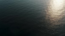 Aerial drone shot of Sunlight Reflection On The Water Surface Of the beach in Central america. 