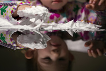toddler girl playing with foam and shaving cream 