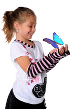 young girl holding her hands out front of her with a butterfly in her hands