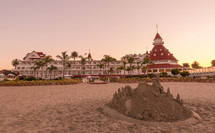 sandcastle on a beach and a resort 