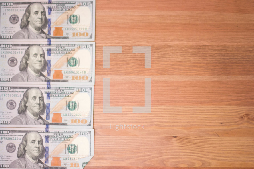 row of one hundred dollar bills