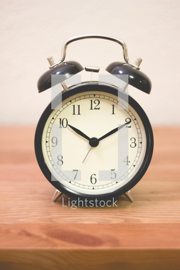 alarm clock on a wood shelf 