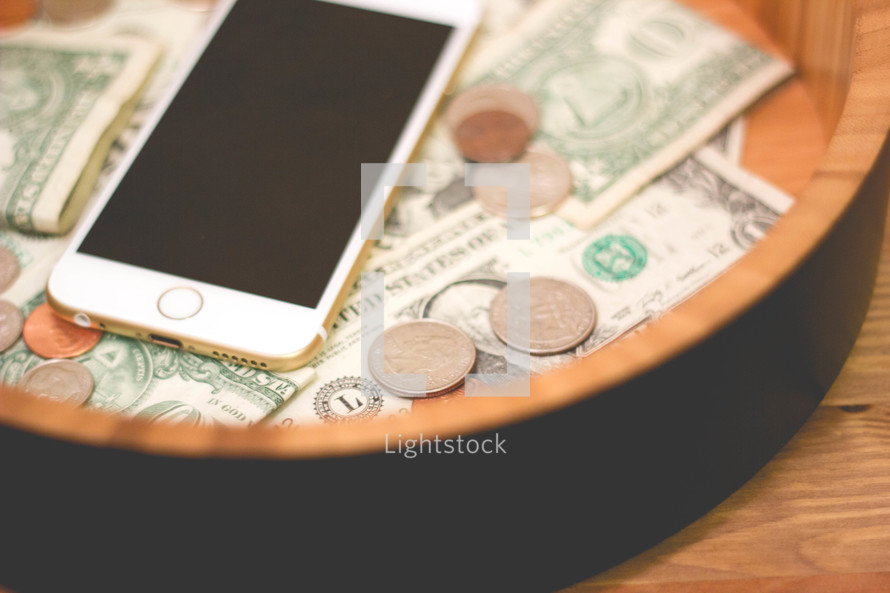 Iphone and money in a bowl 