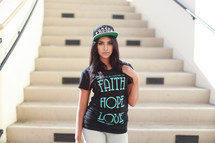 woman modeling religious t-shirts and ball cap 