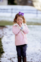 a girl praying outdoors in snow 