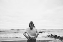 a woman standing on a beach 