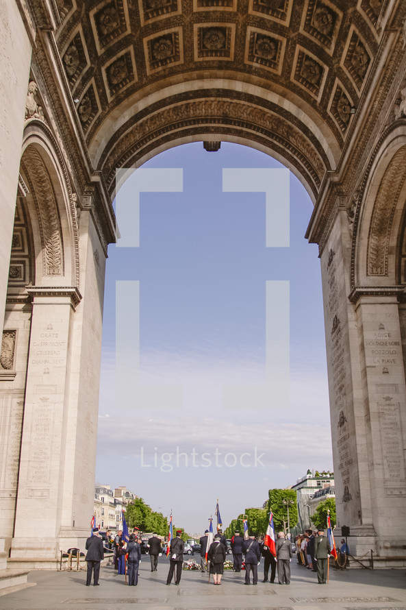 standing under the Arc de Triomphe