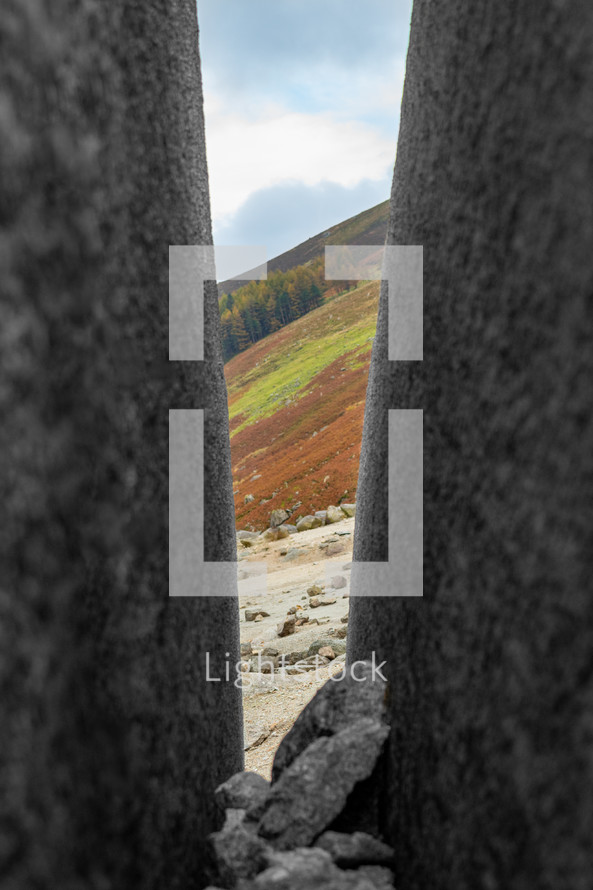 View of Mountains Through a Split Boulder