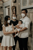 a family at their infants baptism 