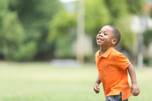 A smiling boy running 
