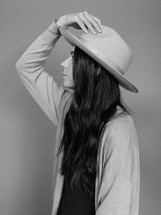 side profile of a woman in a hat 