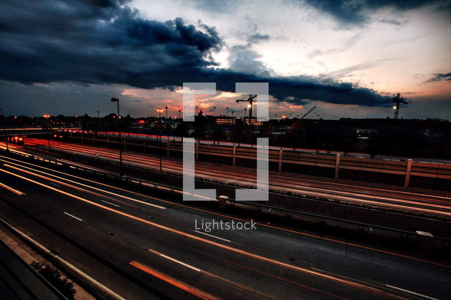 highway at dusk with storm clouds