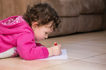 a child drawing on paper 