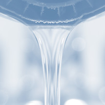 flowing water from a faucet - blue-tinted photograph