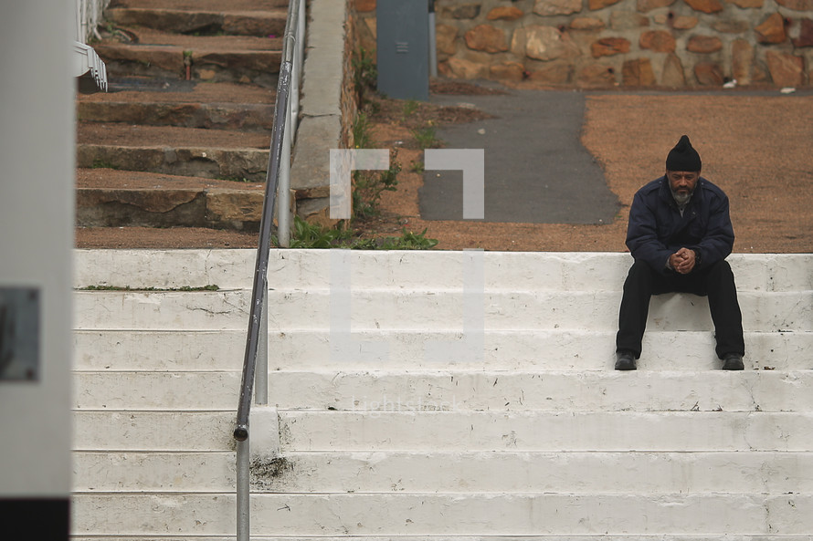 Man sitting on concrete steps