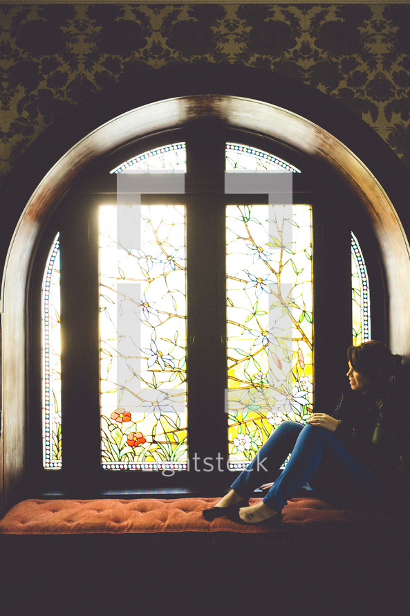 woman sitting in a window