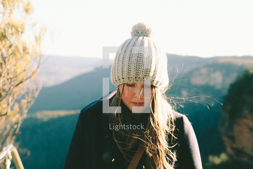 woman in a knit hat looking down 
