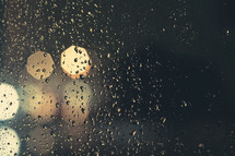 rain drops on a window and bokeh lights at night 