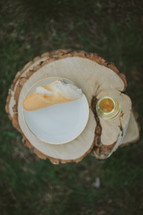 bread and wine on a tree stump for a wedding communion 