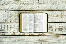 open Bible on weathered wood boards 