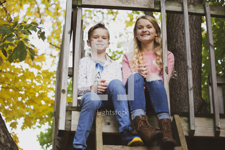 brother and sister in a tree house 