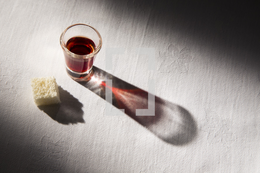 communion elements on a white table cloth 