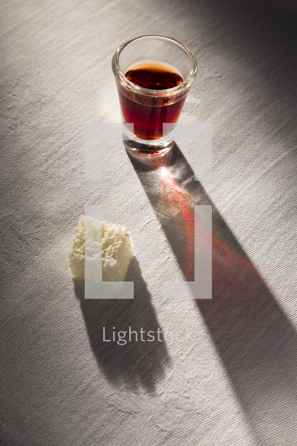 communion elements on a white table cloth 
