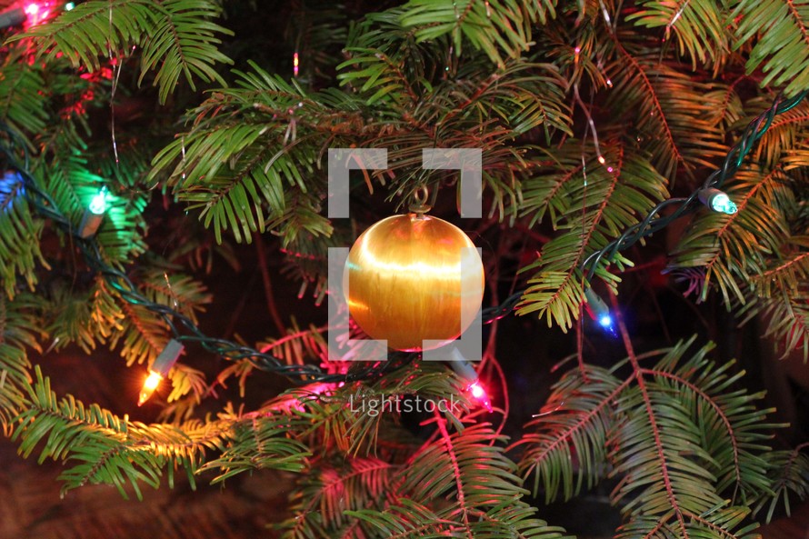 Christmas ornaments and lights on a decorated Christmas tree 